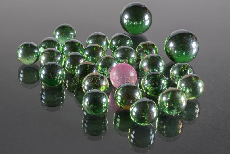 Small Emerald Green Glass Balls with Reflection and One Pink Ball Stock