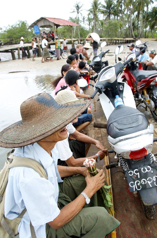 Small ferry boat full of locals trying to cross the river