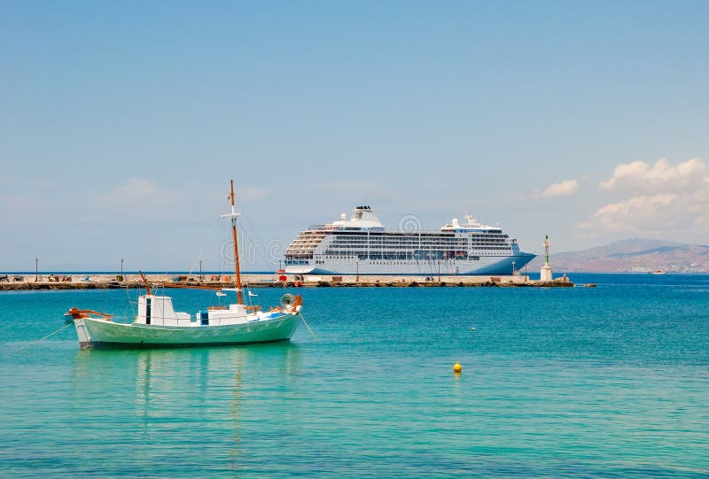 A small fishing boat and large cruise ship