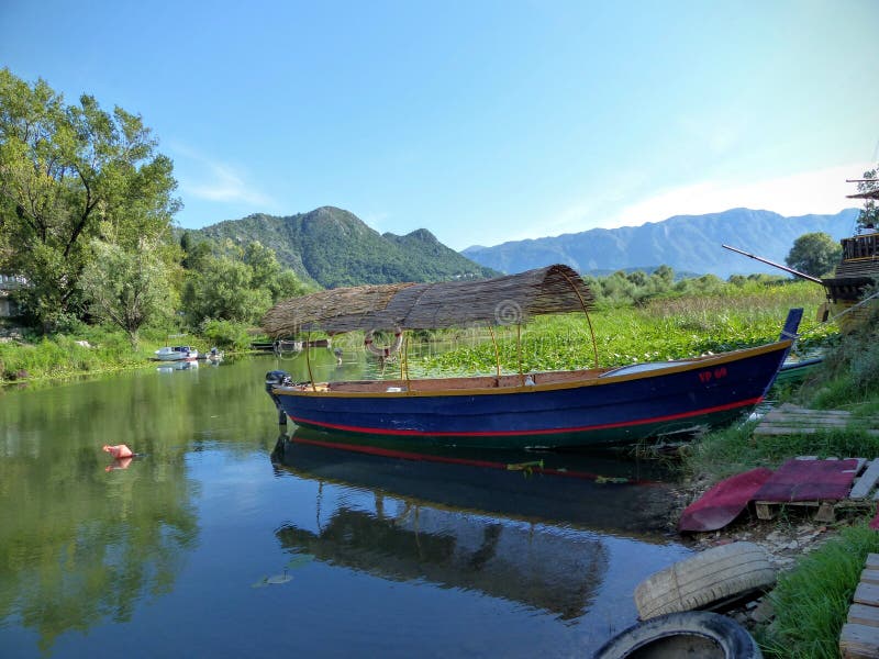 Small fishing boat in the village of Virpazar, situated on the south shore west of the lake of Skadar, Montenegro. royalty free stock photography Small fishing boat in the village of Virpazar, situated on the south shore west of the lake of Skadar, Montenegro. royalty free stock photography