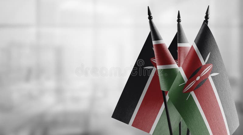 Small flags of the Kenya on an abstract blurry background stock illustration