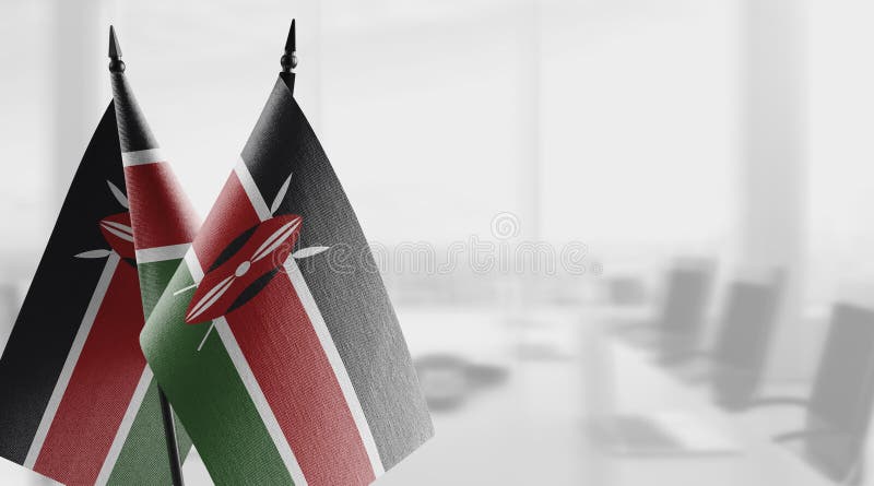 Small flags of the Kenya on an abstract blurry background royalty free illustration