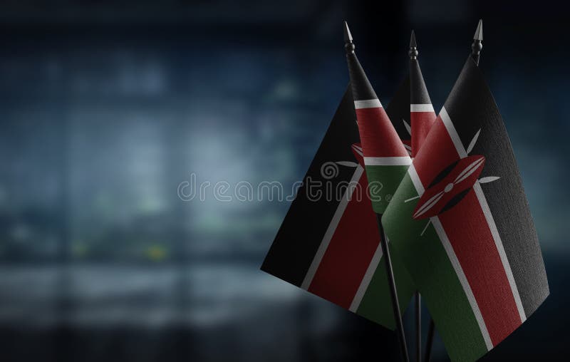 Small flags of the Kenya on an abstract blurry background vector illustration