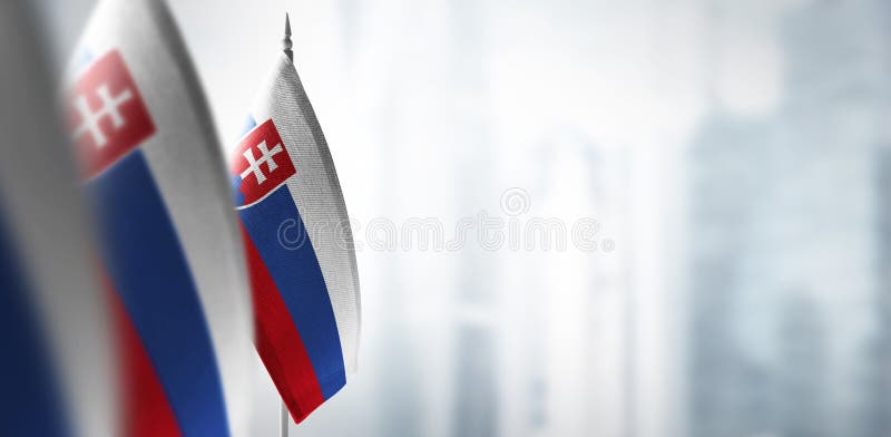 Small flags of Slovakia on a blurry background of the city