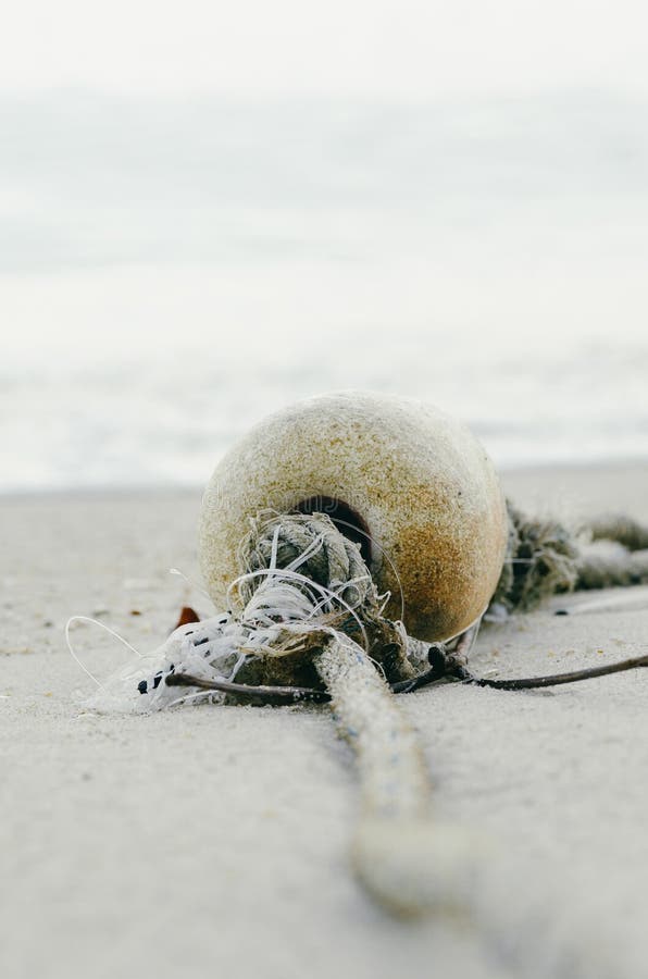 Small Foam Ball Buoy for Fishing Net Float Stranded on Sandy Beach