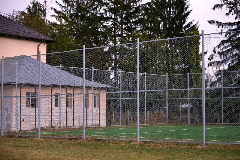 Small Football Pitch Surrounded by Fences in a School Playground Area