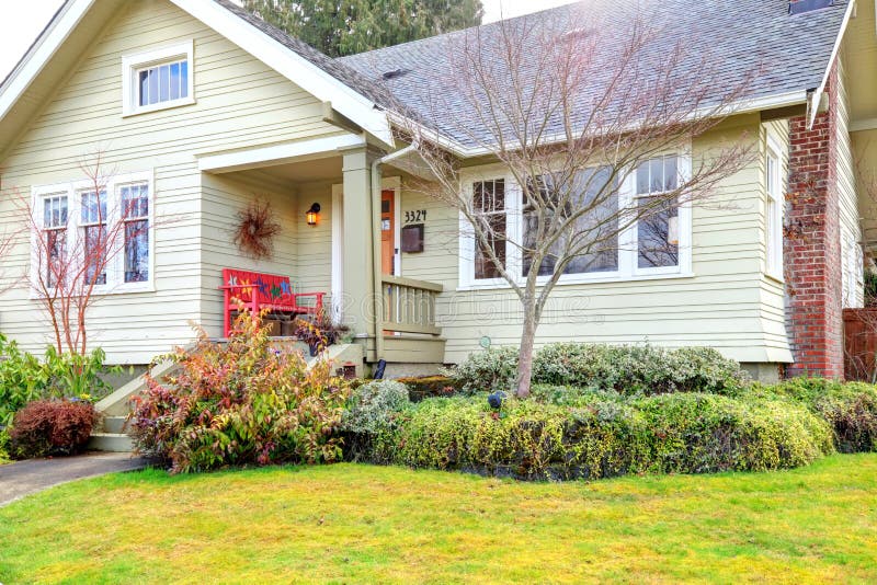 Siding house with column front porch and wood red bench. Siding house with column front porch and wood red bench