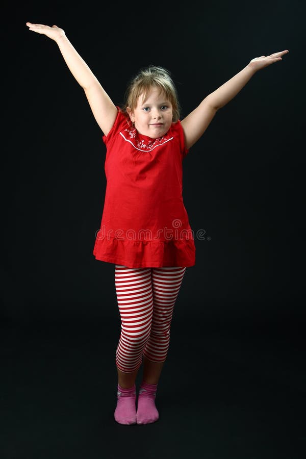 Small Girl Dancing in Red Casual Clothes on Black Stock Photo Image