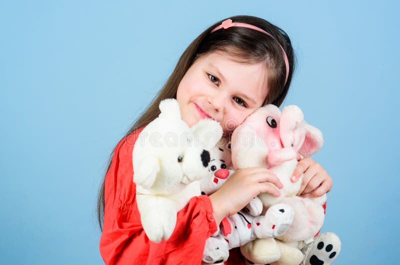 Small girl smiling face with favorite toys. Happy childhood. Little girl play with soft toy teddy bear. Sweet childhood stock image Small girl smiling face with favorite toys. Happy childhood. Little girl play with soft toy teddy bear. Sweet childhood stock image