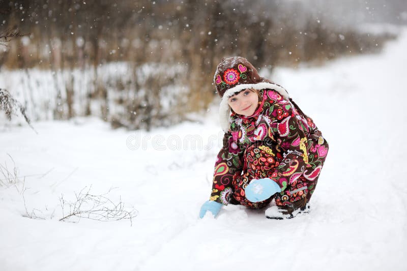 Small girl in strong snow fall