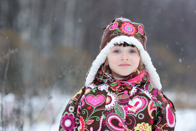 Small girl in strong snow fall