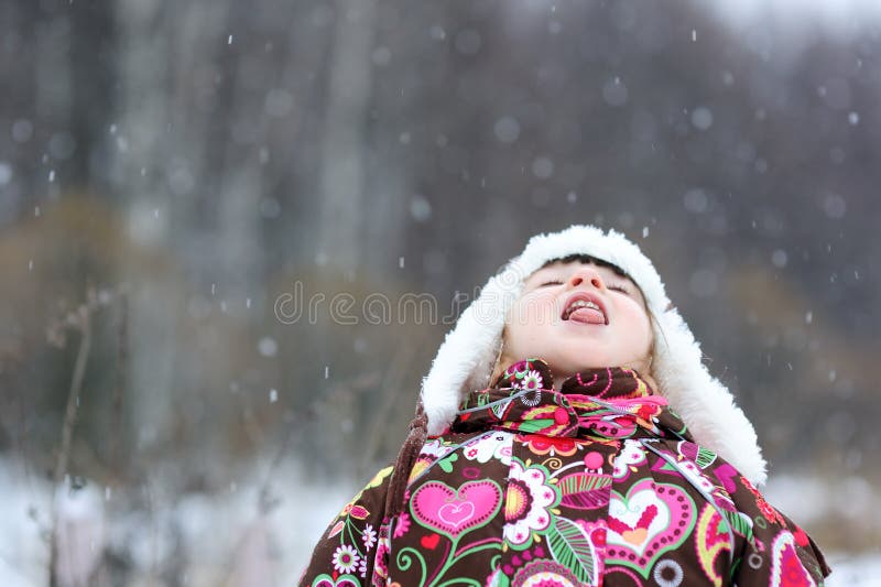 Small girl in strong snow fall