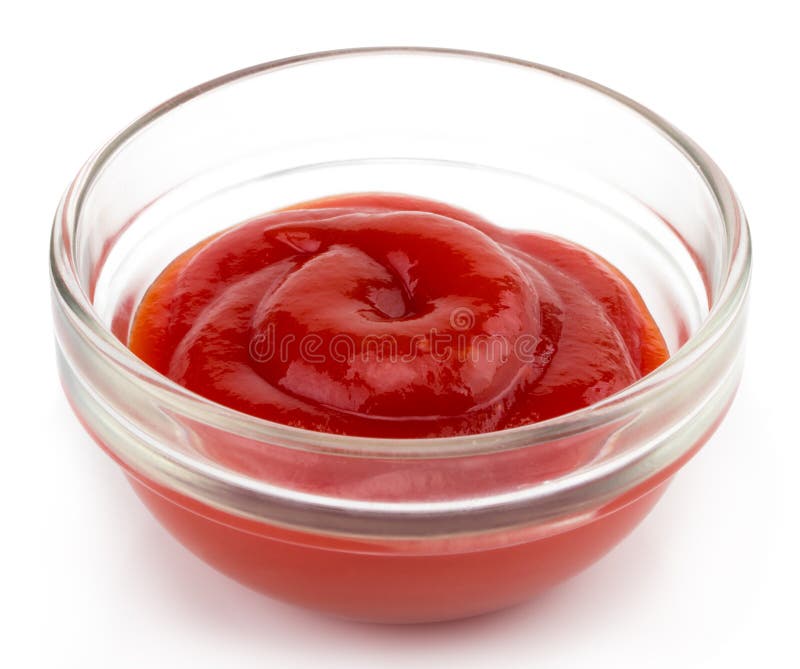 Small glass condiment bowl of red tomato sauce ketchup. Isolated