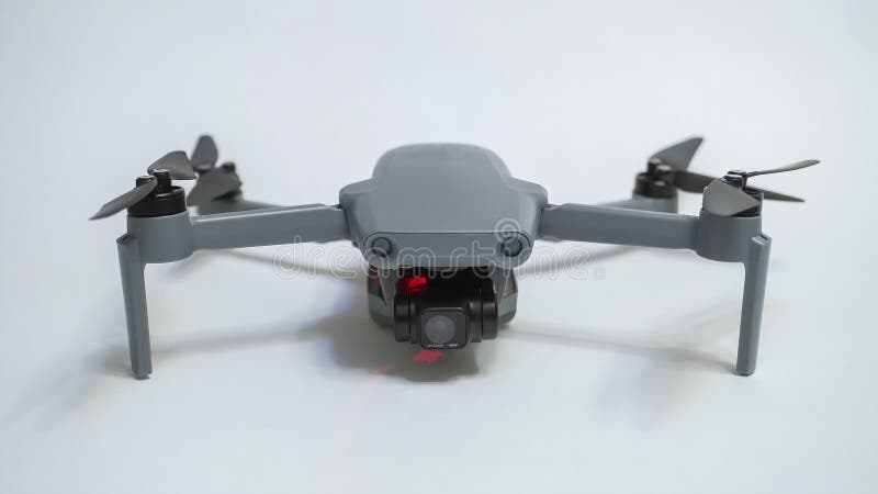 Small gray folding quadcopter with three-axis gimbal camera stock photo
