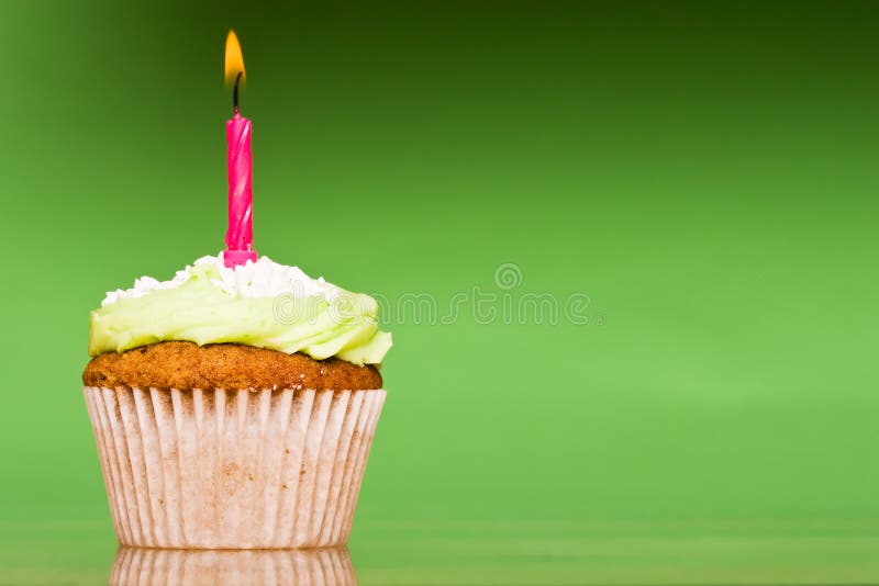 Small green cake with a single candle