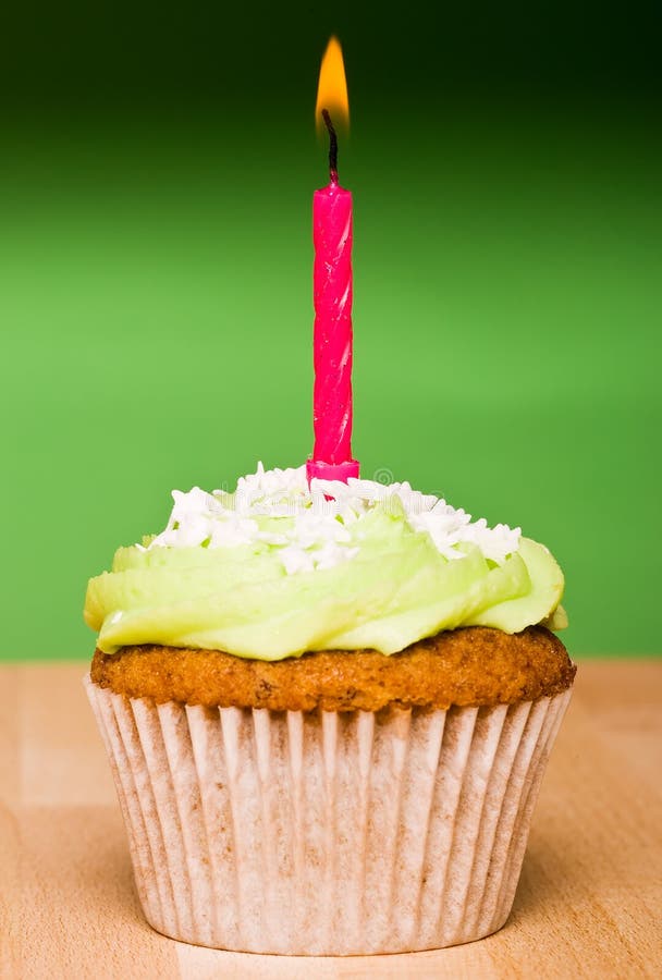 Small green cake with a single candle