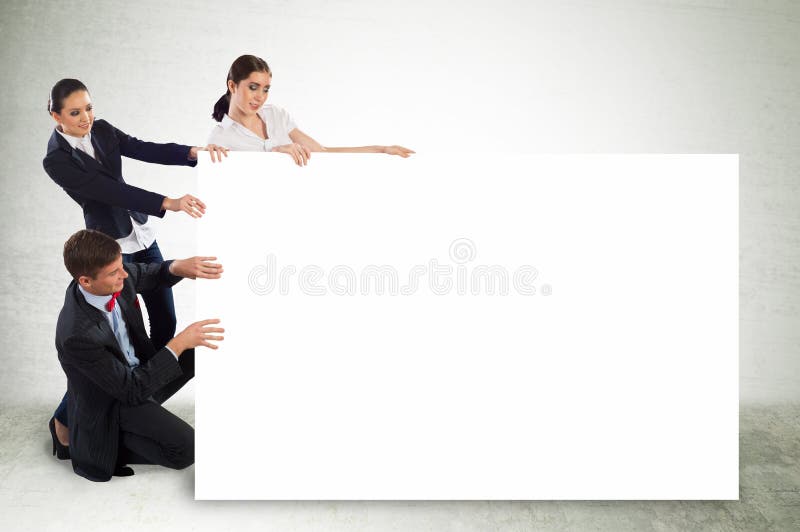 Small group of people holding a blank banner royalty free stock images