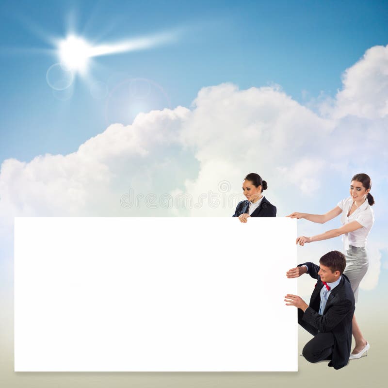 Small group of people holding a blank banner royalty free stock image