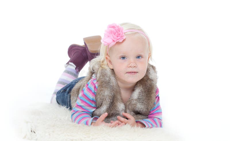 Small happy girl in a fur vest stock photo Small happy girl in a fur vest stock photo