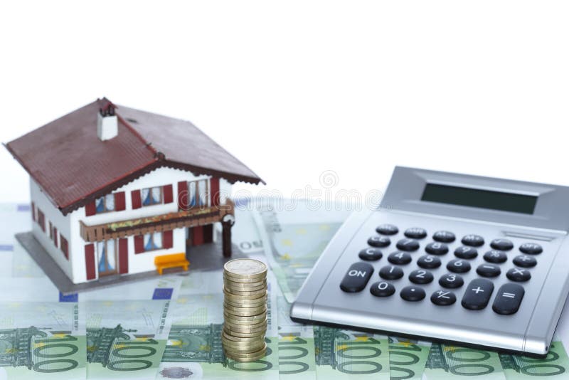 A small house with calculator stock photo A small house with calculator stock photo