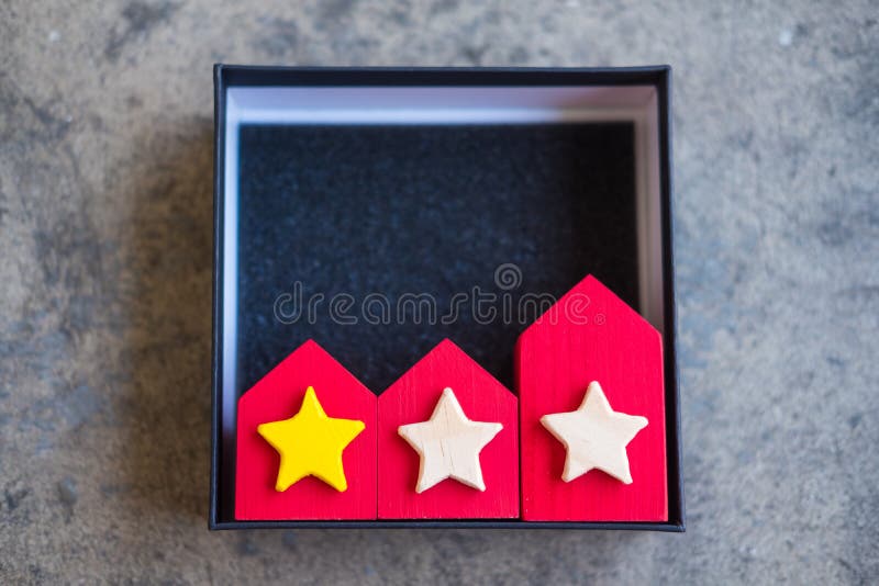Small house with stars and the best property with rating a yellow star in black box stock images