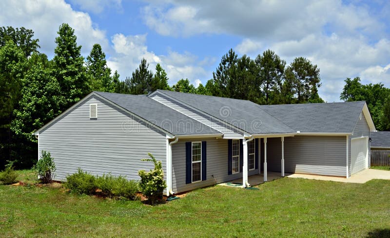 A small house with vinyl siding.