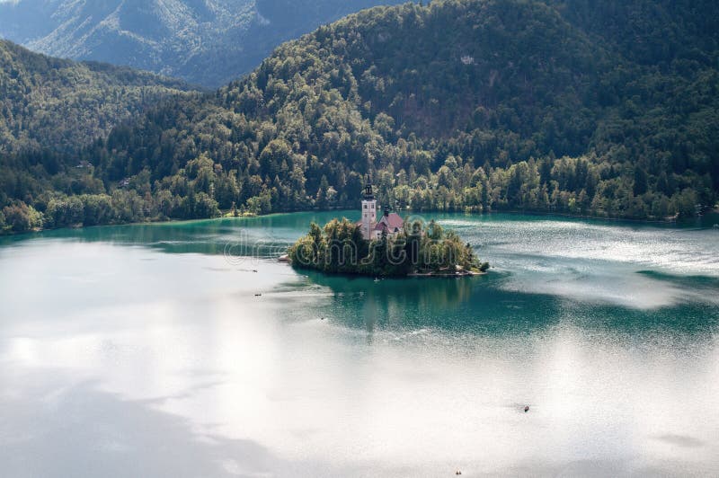 Ostrov s kostolom s vysokou vežou uprostred jazera Bled v Slovinsku.