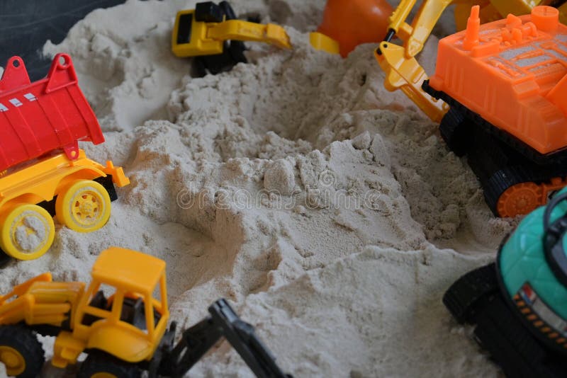 Small Kid Toy Vehicle Construction in Sand Playground Stock Photo