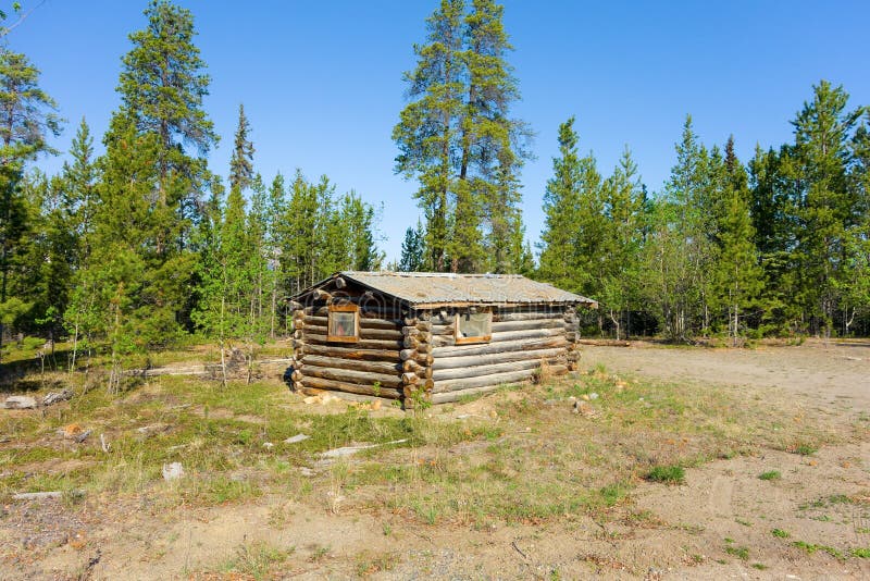 A small log cabin in the wilderness stock image