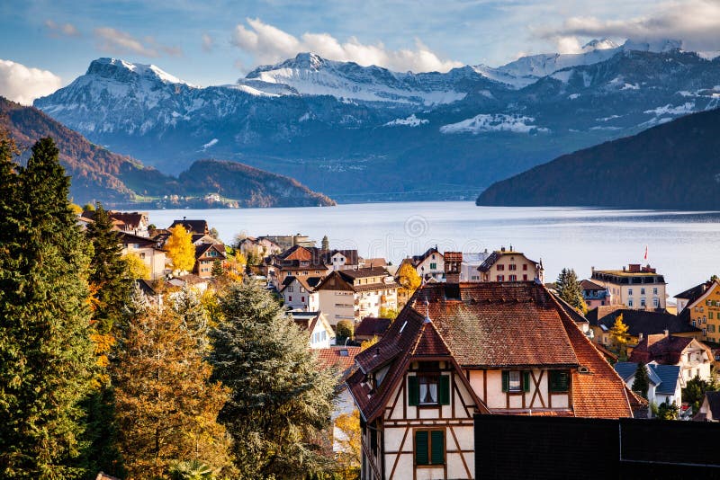 small mountain village and snowy peaks of Alps in the background