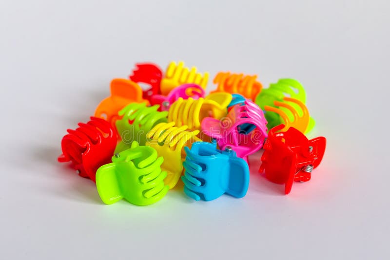 Small Multicolored Plastic Hair Clips on a Light Background Stock Photo