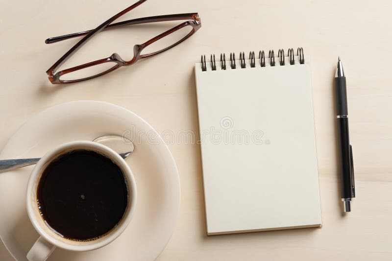 Small notebook and coffee cup