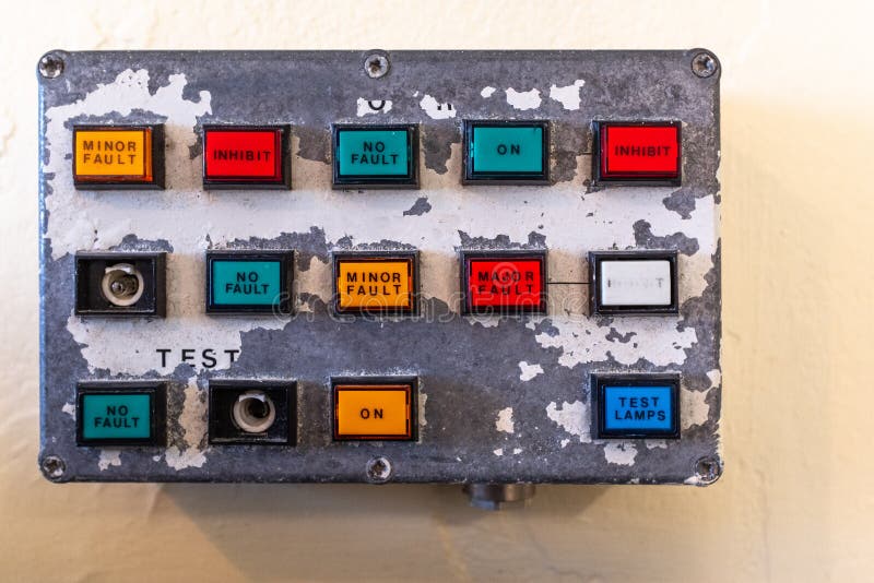 A small old control panel showing buttons of various colours on old paint peeling panel stock image A small old control panel showing buttons of various colours on old paint peeling panel stock image