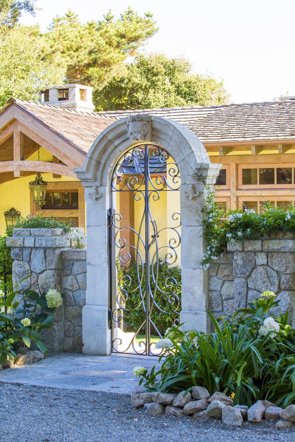 Small old house. Front fenced yard with gate. View of walkway and entrance porch