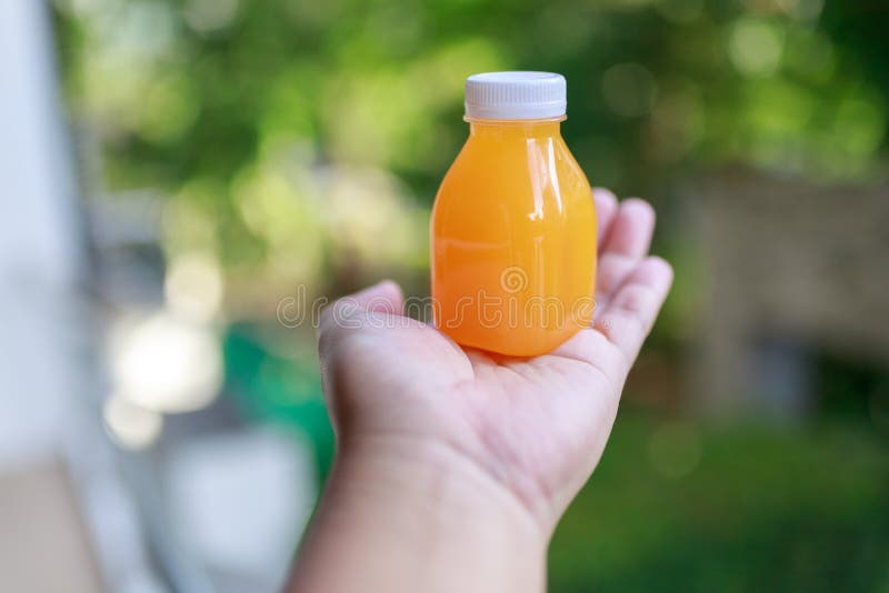 Small Orange Juice Bottle on Hand Stock Image Image of container