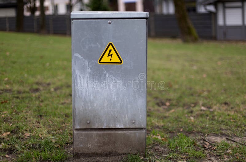 A Small Outdoor Electrical Panel Standing in the Park Stock Photo