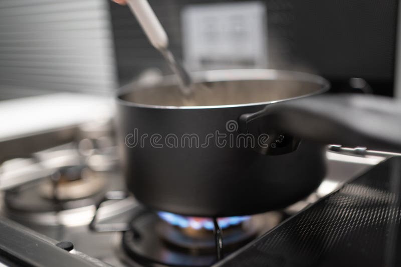 The Small Pan with the Food Stands on the Gas Burner in a Small Camper