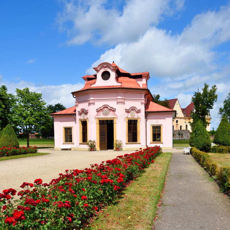 Small pink summerhouse with roses royalty free stock image