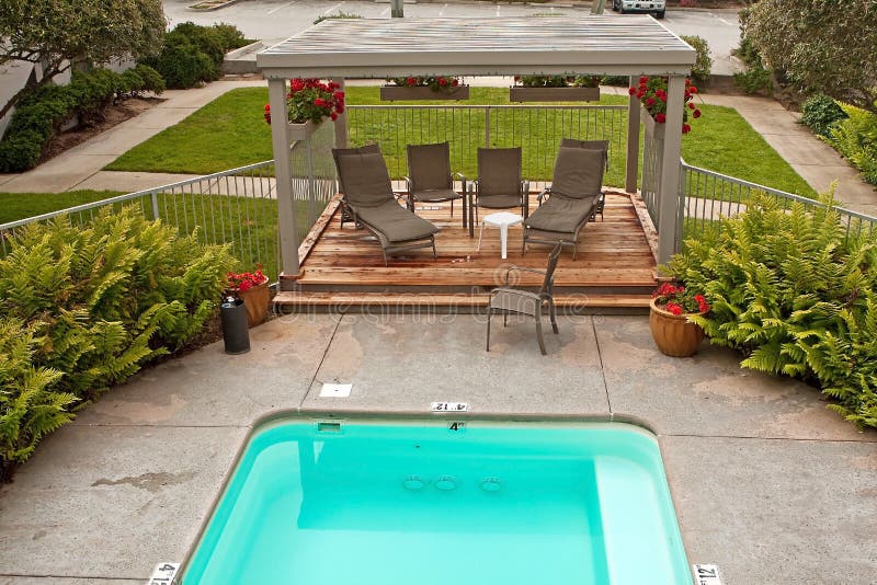 Small pool and wood deck and greenery stock image