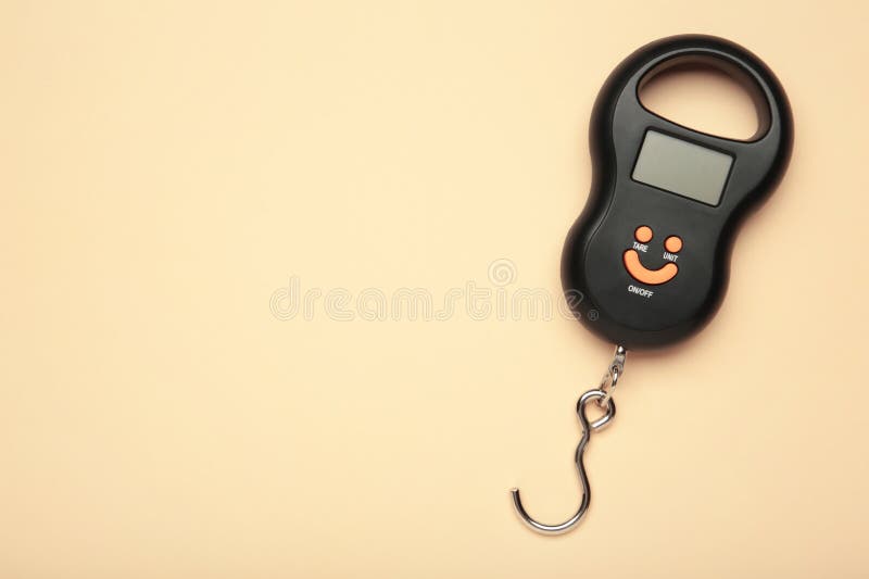 Small portable electronic scale on beige background. Space for text stock photography