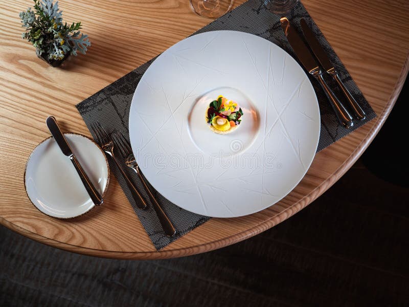 A Small Portion of Herbs and Vegetables, Served on a Ceramic Plate, the