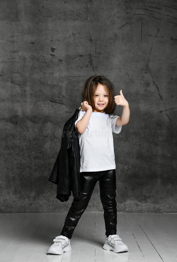 Small Positive Girl in Black and White Rock Style Casual Clothing and White  Sneakers Standing and Showing Thumb Gesture Stock Image - Image of  concrete, leather: 167145349