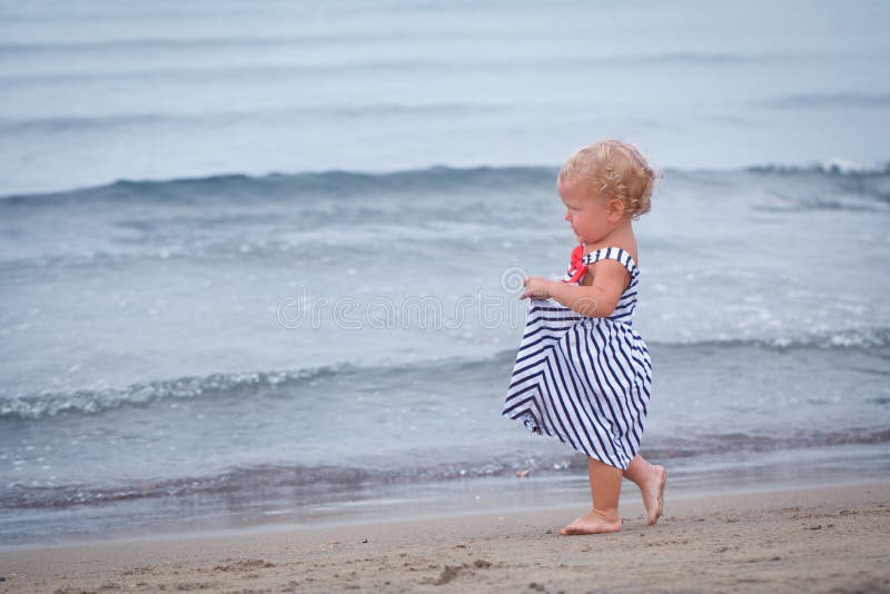 Small Pretty Baby Girl Walking Along Seashore Stock Photo - Image of ...