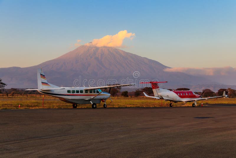 Small propeller airplanes on background of Meru mountain in Arusha airport, Tanzania