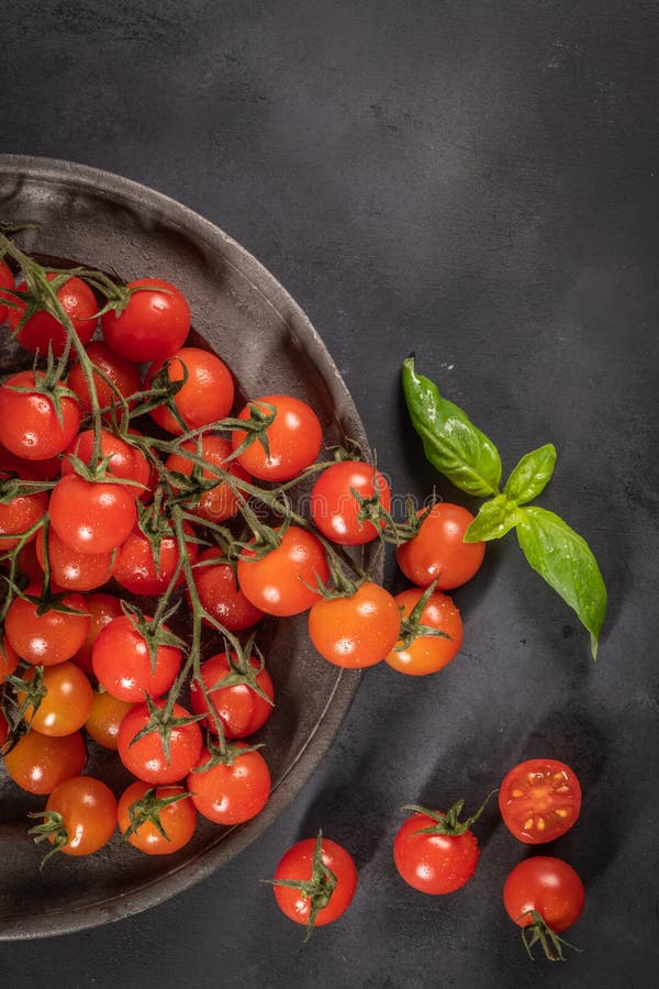 Small Red Cherry Tomatoes on Rustic Background. Cherry Tomatoes Stock