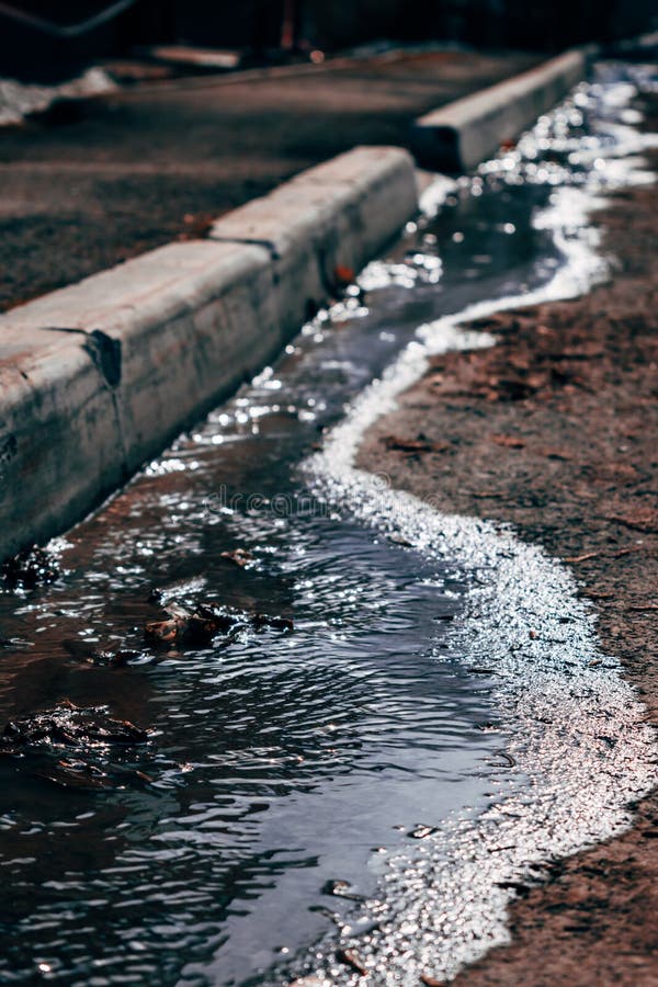 A small river flowing in the courtyard of the house with the onset of spring. stock images