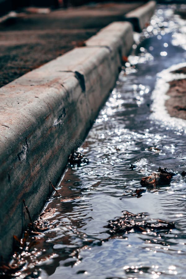 A small river flowing in the courtyard of the house with the onset of spring. stock photo