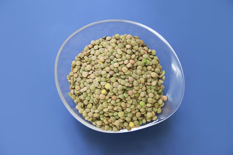 Small Round Grains of Natural Green Lentils in a Decorative Plate Stock