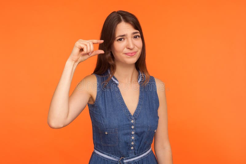 small-scale-positive-brunette-woman-denim-dress-showing-little-bit-gesture-looking-disappointment-small-scale-171950047.jpg