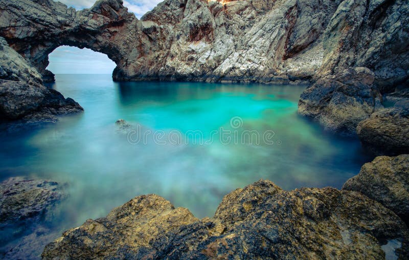 A small sea lagoon with a stone arch, Crete stock images A small sea lagoon with a stone arch, Crete stock images